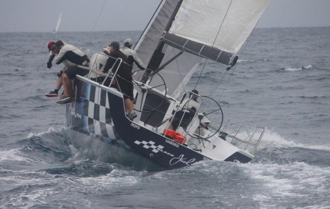 Queensland IRC Championship. Black Jack Too leads the fleet in Race One as the wind builds ahead of the rain squall.  © Tracey Johnstone
